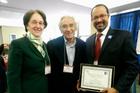 Professor Derrick L. Cogburn (r) poses with Milton Greenberg (c) and Professor Naomi Barron, director of the Center for Teaching, Research, and Learning. Photo courtesy of COTELCO.